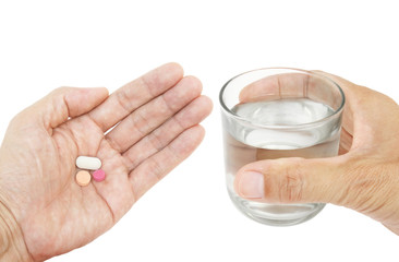 Pills and glass of water in hand isolated on white background