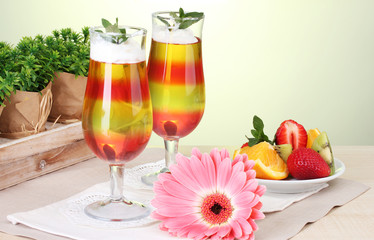 fruit jelly in glasses and fruits on table in cafe