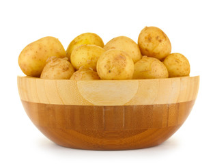 young potatoes in a wooden bowl isolated on white