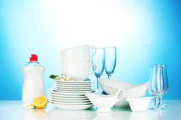 empty clean plates, glasses and cups with dishwashing liquid