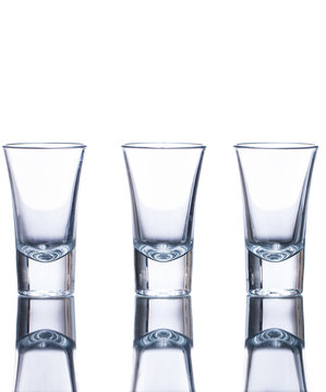 Three empty shot glasses