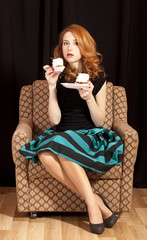 Naklejka premium Redhead girl secretly eating cake.