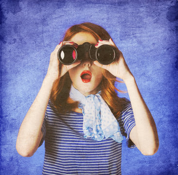American redhead girl in suglasses with binocular