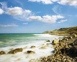 Sea Sky stones.Wave winding coastline accrue at..