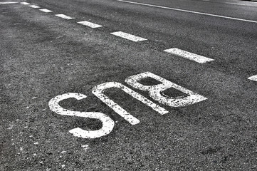 bus sign on tarmac road