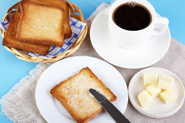 Fototapeta na wymiar Breakfast. A cup of coffee and toasts with butter