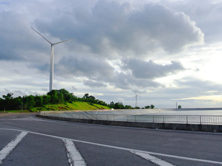 Wind turbine near lake in evening