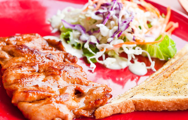 Pork steak with salad and bread