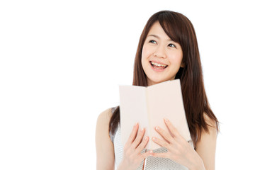 Beautiful young woman reading a book. Portrait of asian.