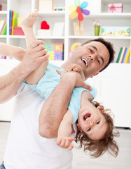 Obraz na płótnie Canvas Father playing with toddler son