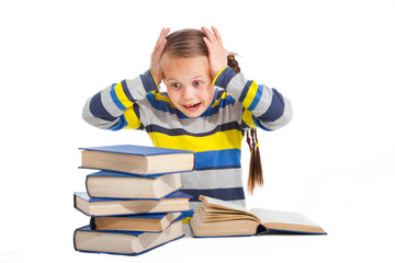 schoolgirl with horror looking at pile of books - 42908556
