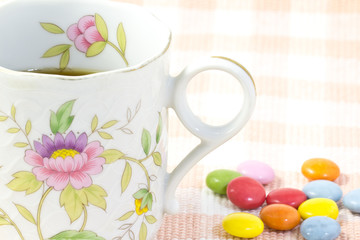 Cup of coffee and colorful chocolate