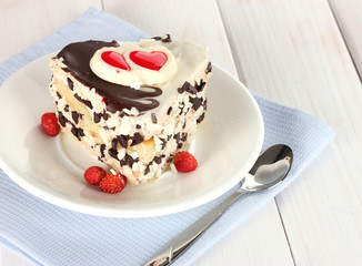 sweet cake with chocolate on plate on wooden table