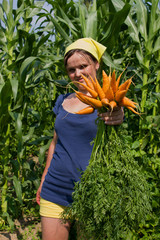 young woman with a bunch of carrots