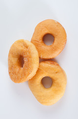 Three donuts with sugar isolated over white