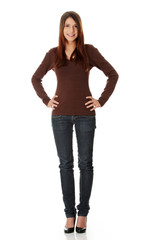 Young beautiful woman is looking straight and smiling.