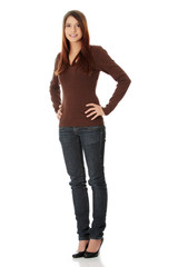 Young beautiful woman is looking straight and smiling.