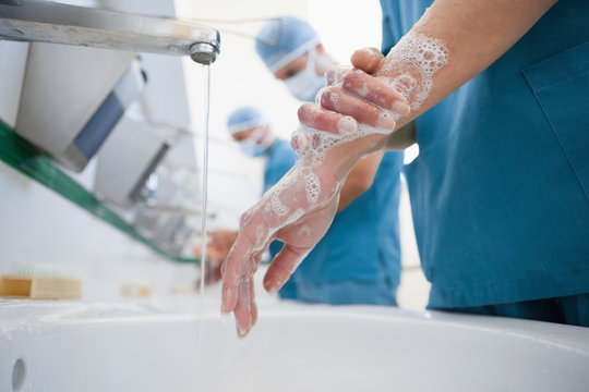 Surgeons in a hospital washing hands