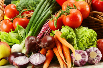 Composition with raw vegetables and wicker basket