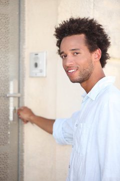 Young opening door