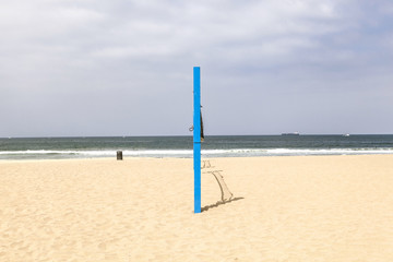 volleyball post at the beach in blue