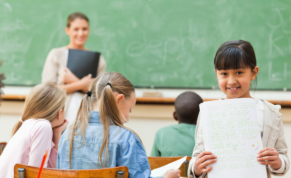 Student with her exercise book in classroom