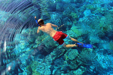 Spear fishing over coral head