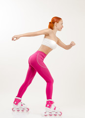 Young red woman on a roller skates
