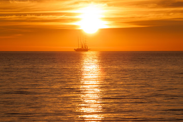 Old tall sail ship silhouette in sunset