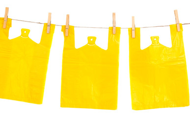 Cellophane bags hanging on rope isolated on white