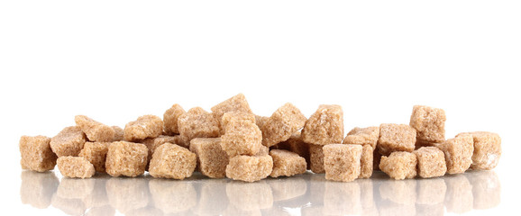 Lump brown cane sugar cubes isolated on white