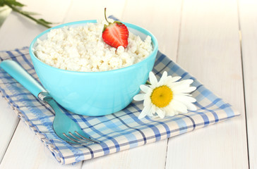 cottage cheese with strawberry in blue bowl and fork