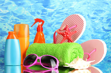 bright beach accessories, on blue sea background