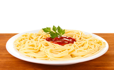 Italian spagetti cooked in a white plate on wooden background