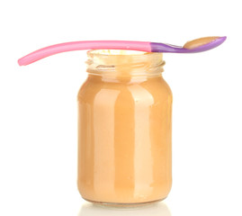 Jar with baby food and spoon isolated