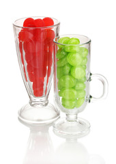Color candies in glasses isolated on white
