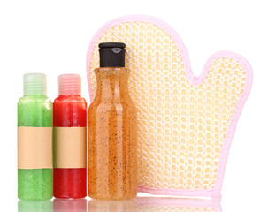 Bottles with scrub and sponge isolated on white