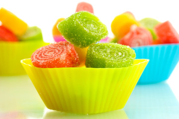 sweet jelly candies in cup cake cases isolated on white.
