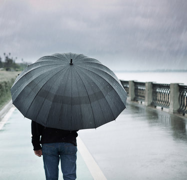 rain and lonely man with umbrella