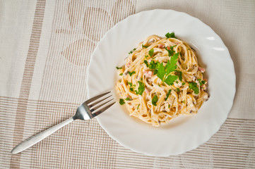 Spaghetti . Fettuccine carbonara in a white bowl
