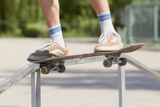Skater doing noseslide on fun-box in skatepark