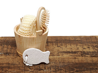 Wooden bucket with SPA accessories isolated on white background.
