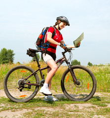 Fototapeta premium Happy Young Woman riding bicycle outside. Healthy Lifestyle