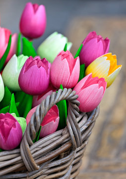 Colorful wooden tulips in a basket