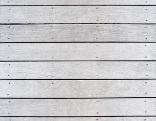 A boat dock's old, weathered and faded wood decking