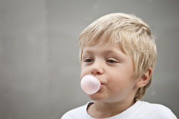 Child blowing a bubble gum