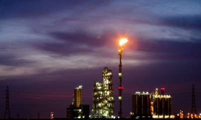 Petrochemical plant and flare at twilight time