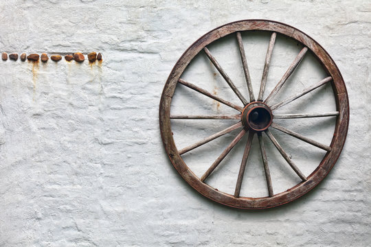 Rustic wagon wheel hanging on a wall