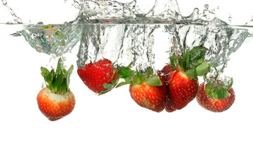 Strawberries Splashing into Water