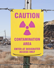 Caution Contamination Area Sign with Ruin Backdrop